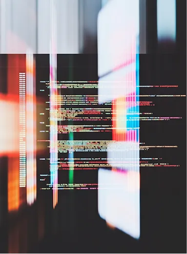 Colorful lines of computer code reflected on a dark, blurred glossy surface.